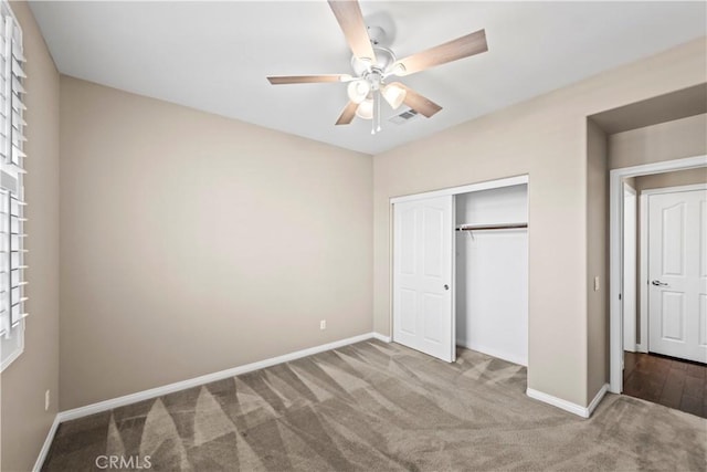 unfurnished bedroom with carpet flooring, ceiling fan, and a closet