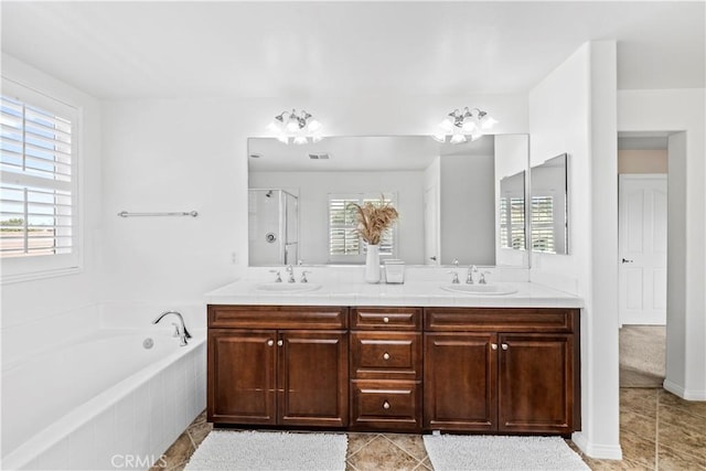 bathroom featuring vanity, tile patterned flooring, a wealth of natural light, and separate shower and tub