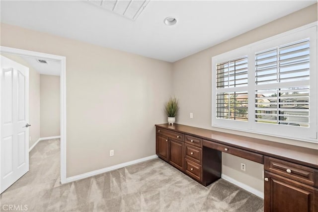 office area featuring light carpet and built in desk