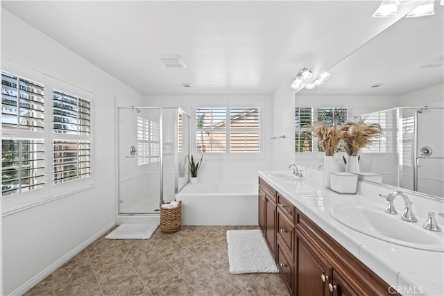 bathroom with tile patterned flooring, vanity, and separate shower and tub