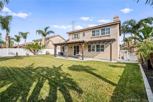 back of property featuring a yard, a pergola, and a patio