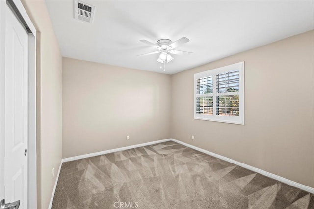 spare room with ceiling fan and carpet flooring