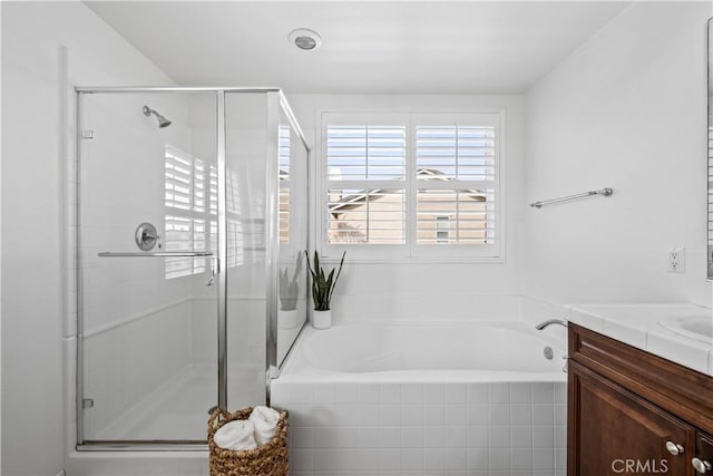 bathroom featuring independent shower and bath and vanity