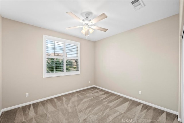 carpeted spare room featuring ceiling fan