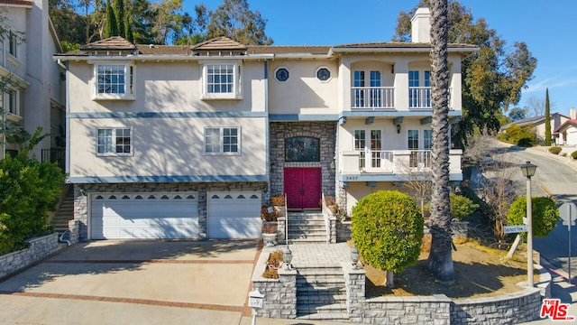 view of front facade featuring a balcony and a garage