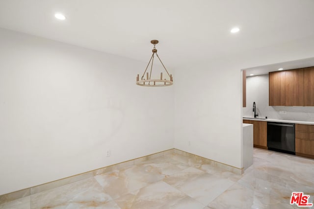 unfurnished dining area featuring a notable chandelier and sink