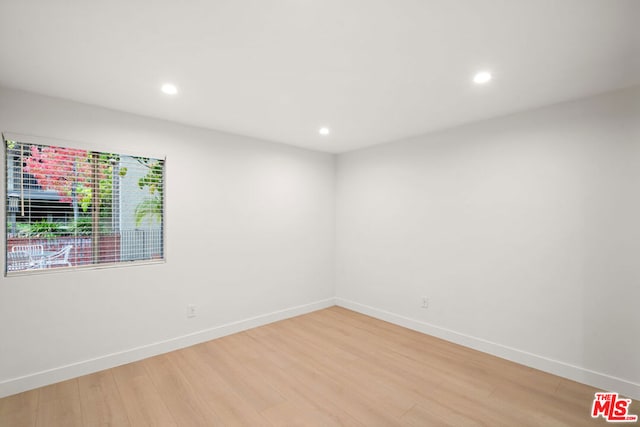 unfurnished room featuring hardwood / wood-style flooring