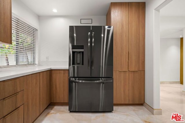 kitchen with black fridge with ice dispenser