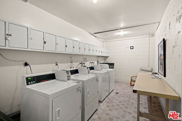 clothes washing area with washing machine and clothes dryer