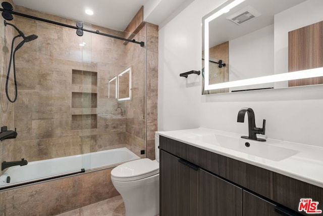 full bathroom featuring vanity, toilet, and enclosed tub / shower combo