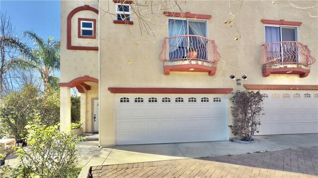 view of front of home featuring a balcony and a garage