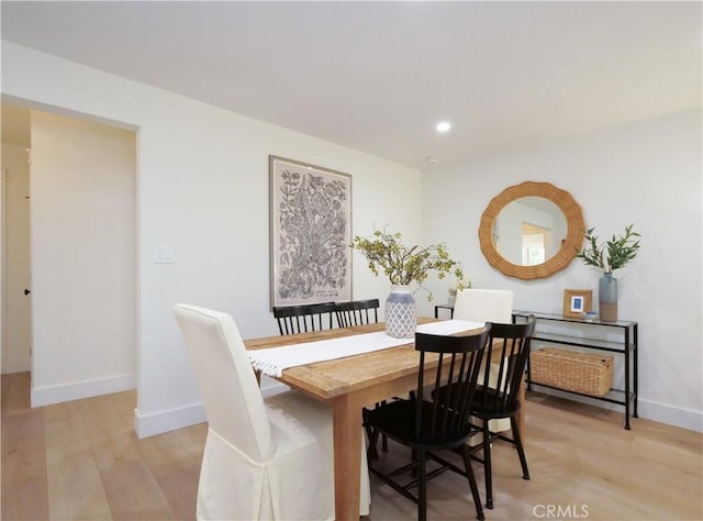 dining space with light hardwood / wood-style floors