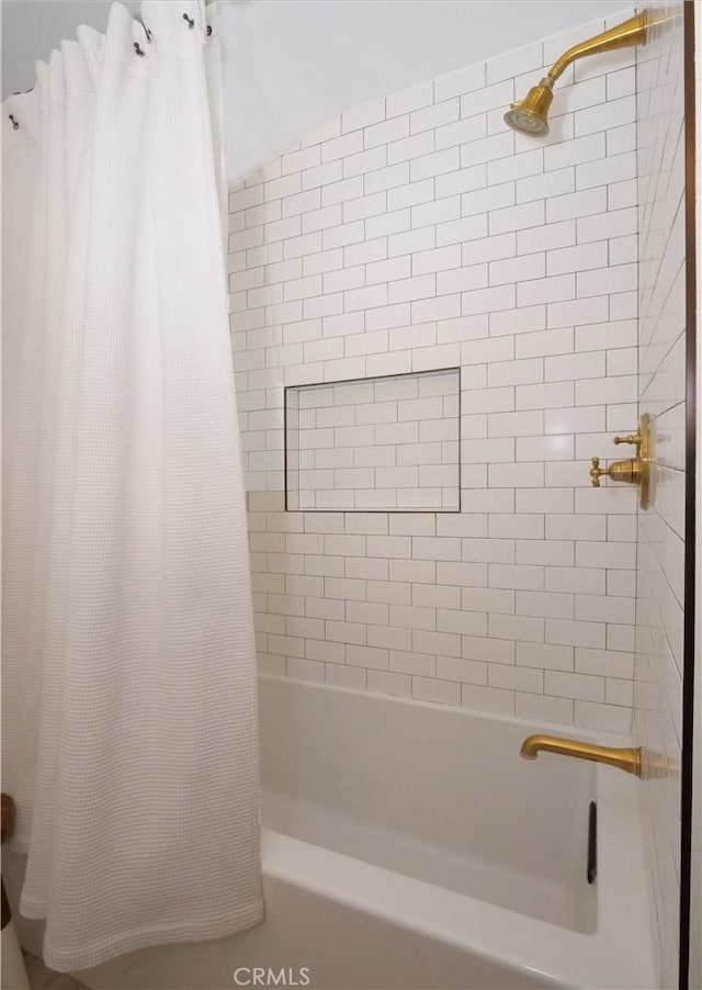 bathroom featuring shower / bath combination with curtain