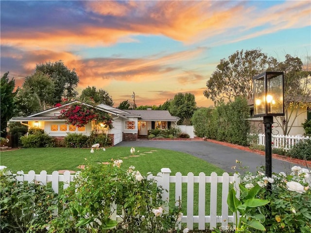 ranch-style house with a lawn