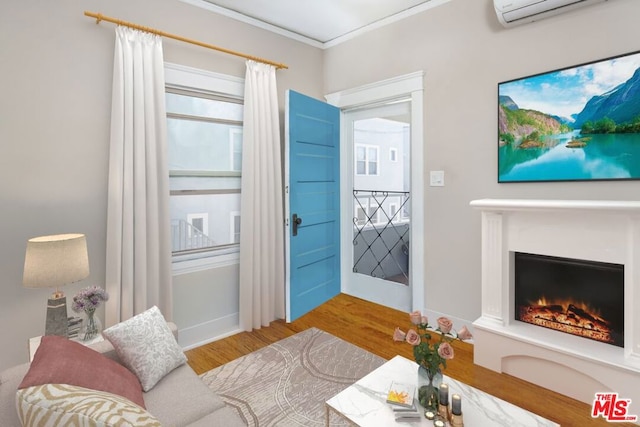 living room with crown molding, light hardwood / wood-style flooring, and a wall unit AC