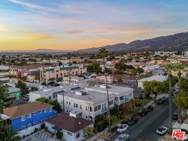 aerial view at dusk featuring a mountain view