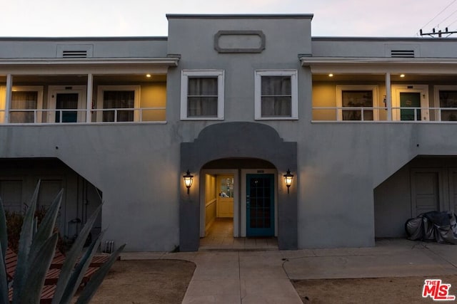 view of front of home featuring a balcony