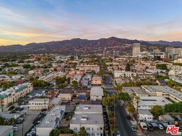 aerial view at dusk featuring a mountain view