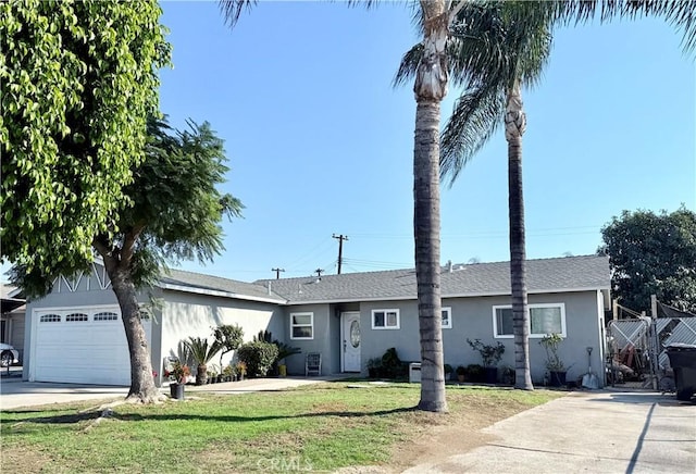 ranch-style home with a garage and a front yard