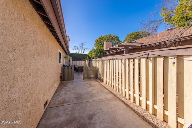 view of side of home with a patio area