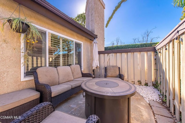 view of patio featuring an outdoor living space with a fire pit