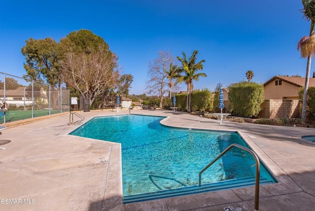 view of swimming pool featuring a patio area