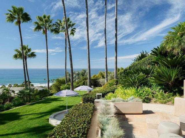 surrounding community featuring a water view and a lawn