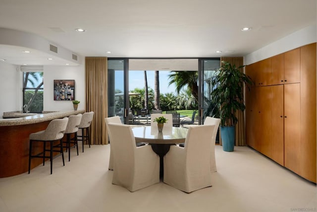 dining area with expansive windows and indoor bar