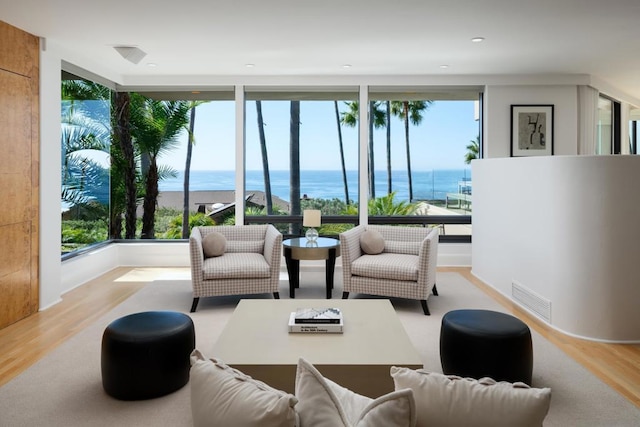 interior space featuring a water view and light hardwood / wood-style floors