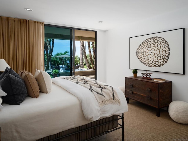 carpeted bedroom featuring expansive windows