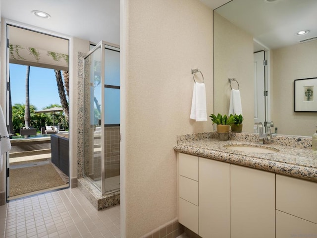 bathroom featuring an enclosed shower, tile patterned floors, and vanity