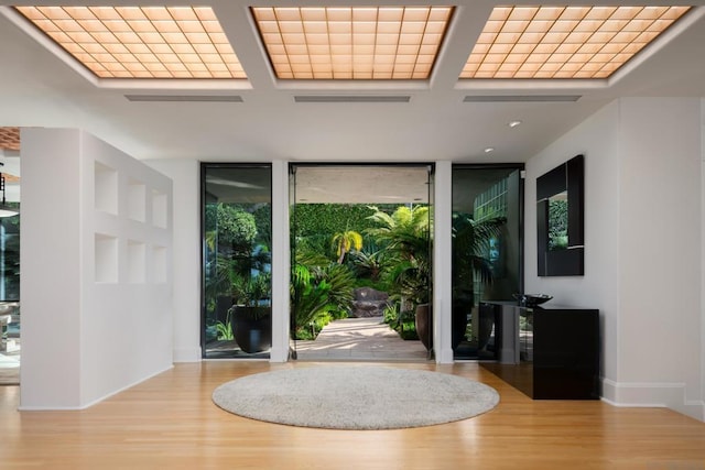 foyer entrance featuring light hardwood / wood-style flooring and expansive windows