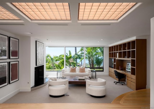 living room with built in desk and expansive windows