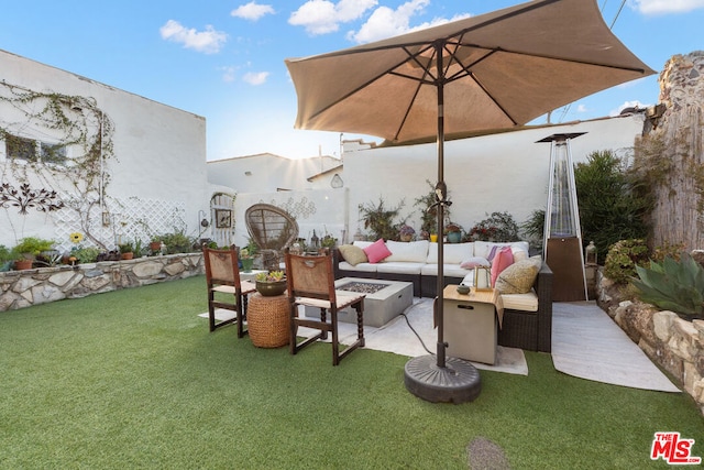 view of patio / terrace with an outdoor living space with a fire pit