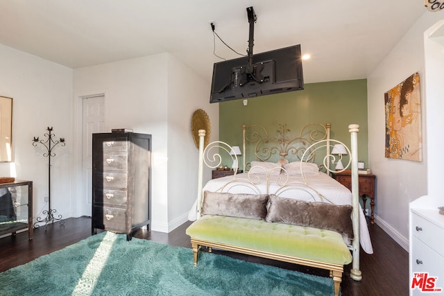 bedroom with dark wood-type flooring