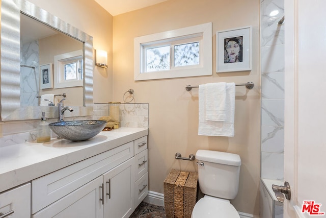 bathroom featuring toilet and vanity