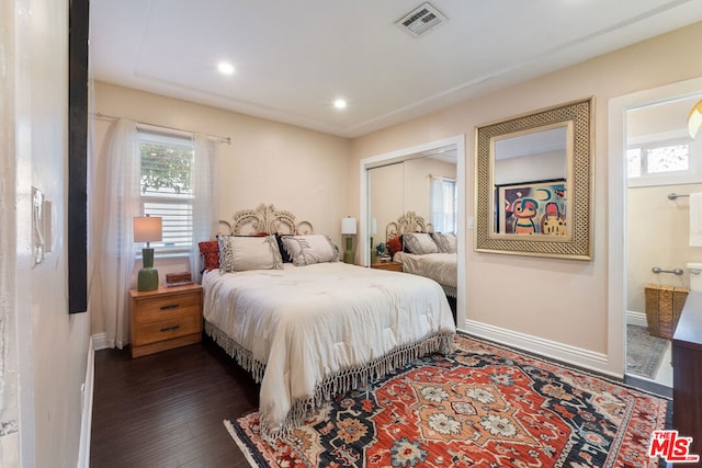 bedroom with a closet and dark hardwood / wood-style floors