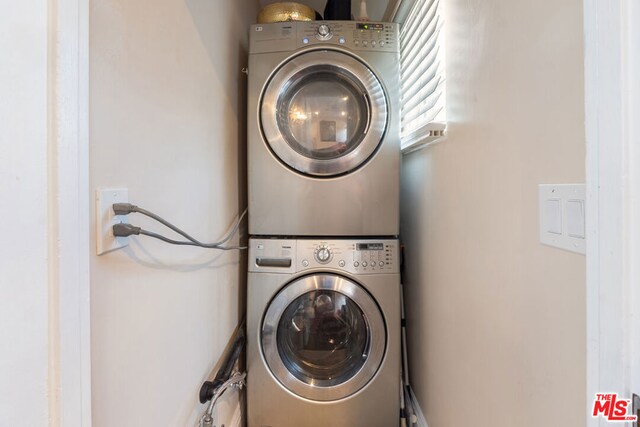 laundry room with stacked washer / dryer