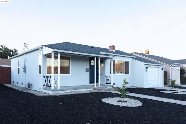 view of front of house with a porch and a garage