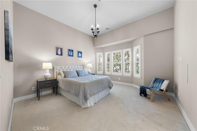 bedroom with light carpet, baseboards, and an inviting chandelier