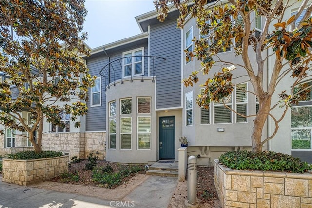 view of front of home featuring fence and stucco siding