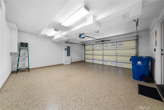 garage with baseboards, electric panel, and a garage door opener