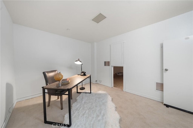 office space featuring baseboards, visible vents, and light colored carpet