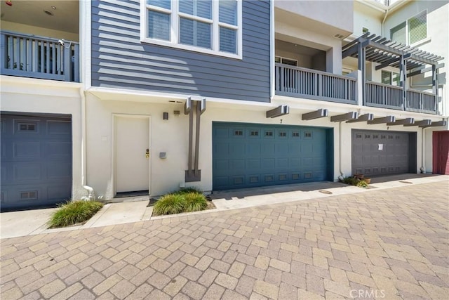 view of front of home featuring a balcony and a garage