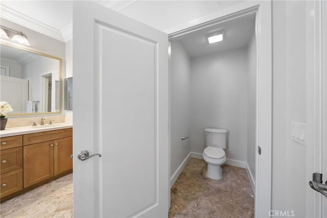 bathroom featuring crown molding, toilet, and vanity