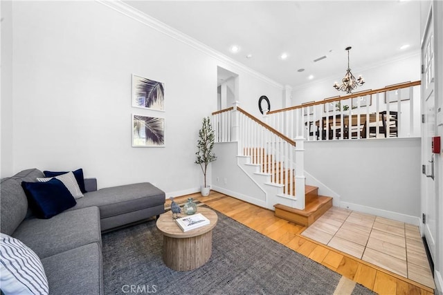 living room featuring a chandelier, ornamental molding, and hardwood / wood-style floors