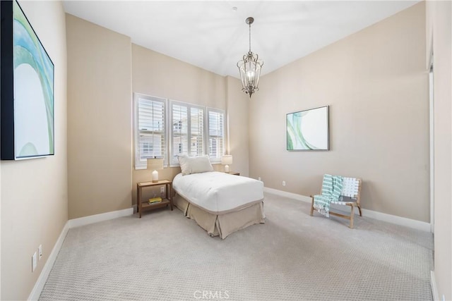 carpeted bedroom with an inviting chandelier