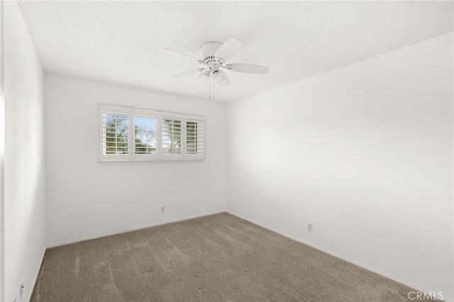 empty room featuring a textured ceiling, carpet floors, and ceiling fan