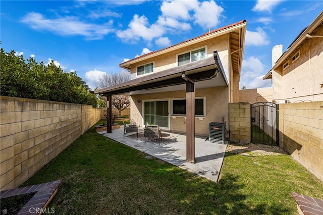 rear view of property with central air condition unit, a yard, and a patio