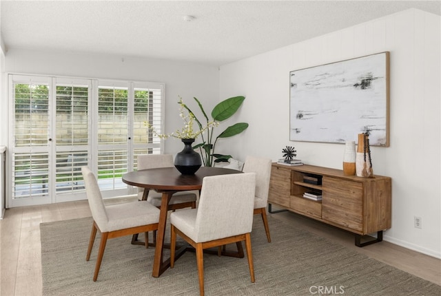 dining area featuring hardwood / wood-style floors and a textured ceiling